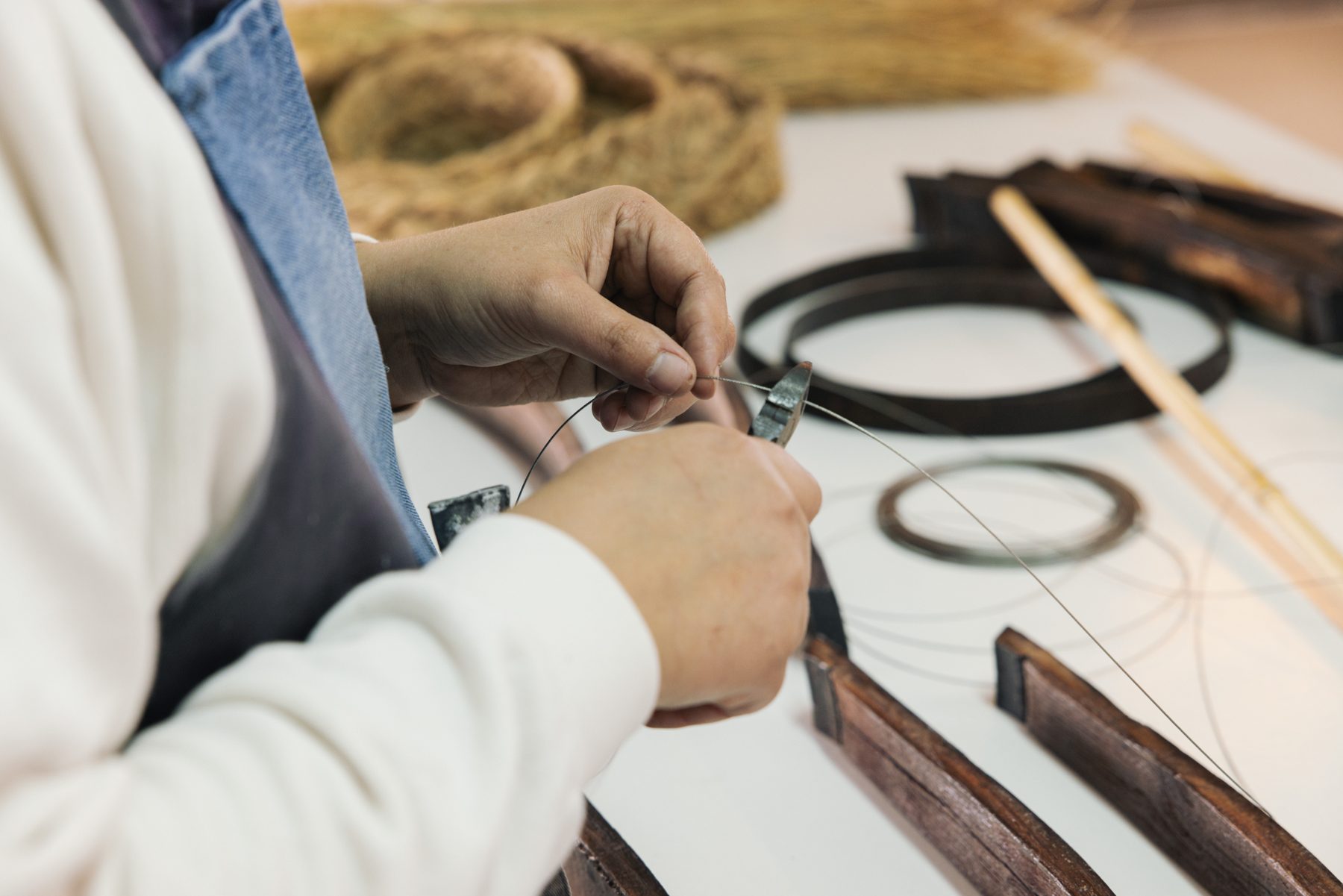 Hands working on wine cask staves