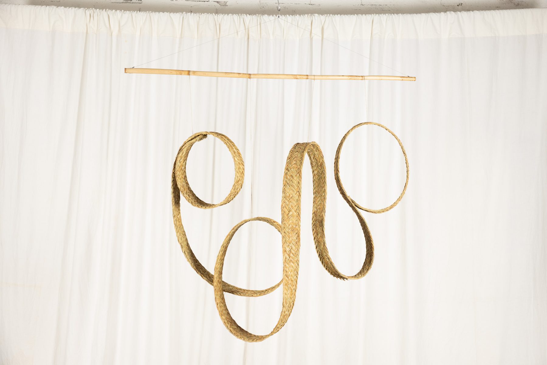 Espart 002, braided esparto sculpture suspended from a cane