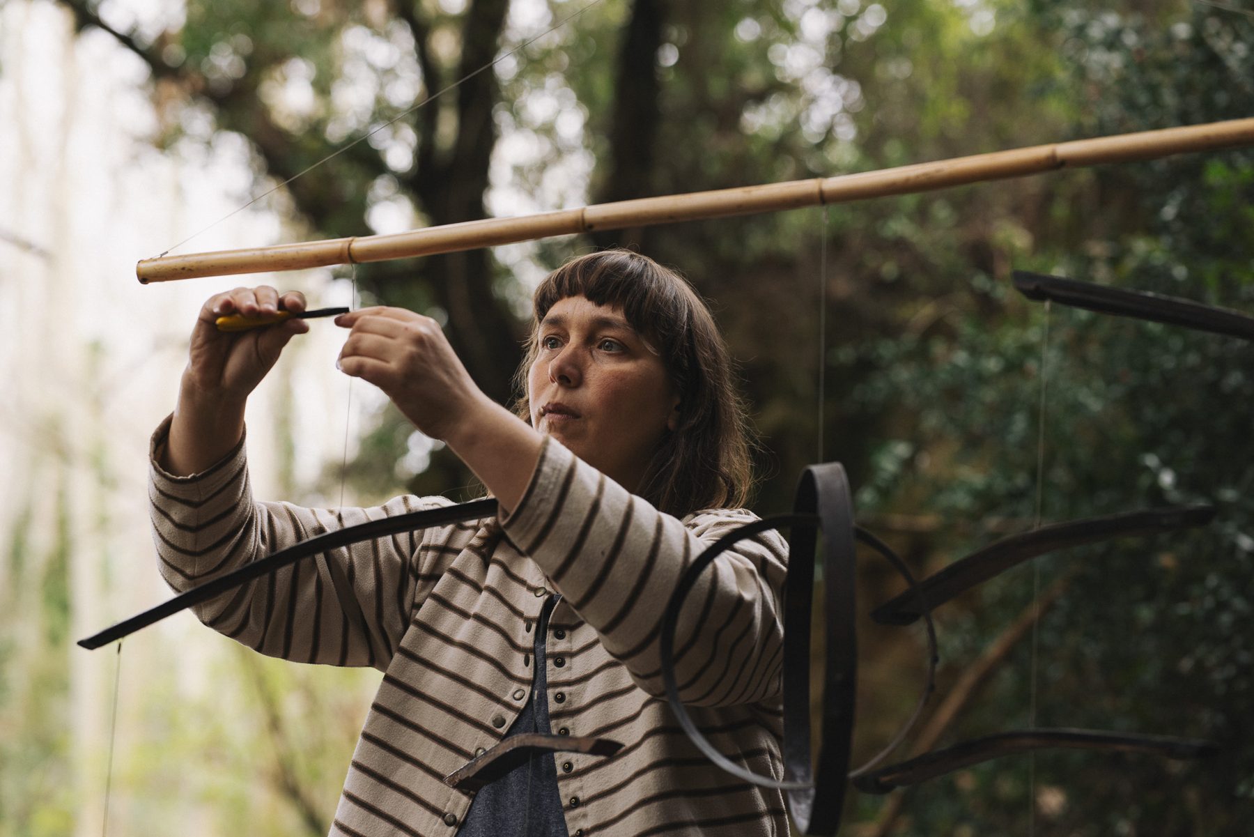 Aloma Lafontana assembling a wine cask mobile outdoors