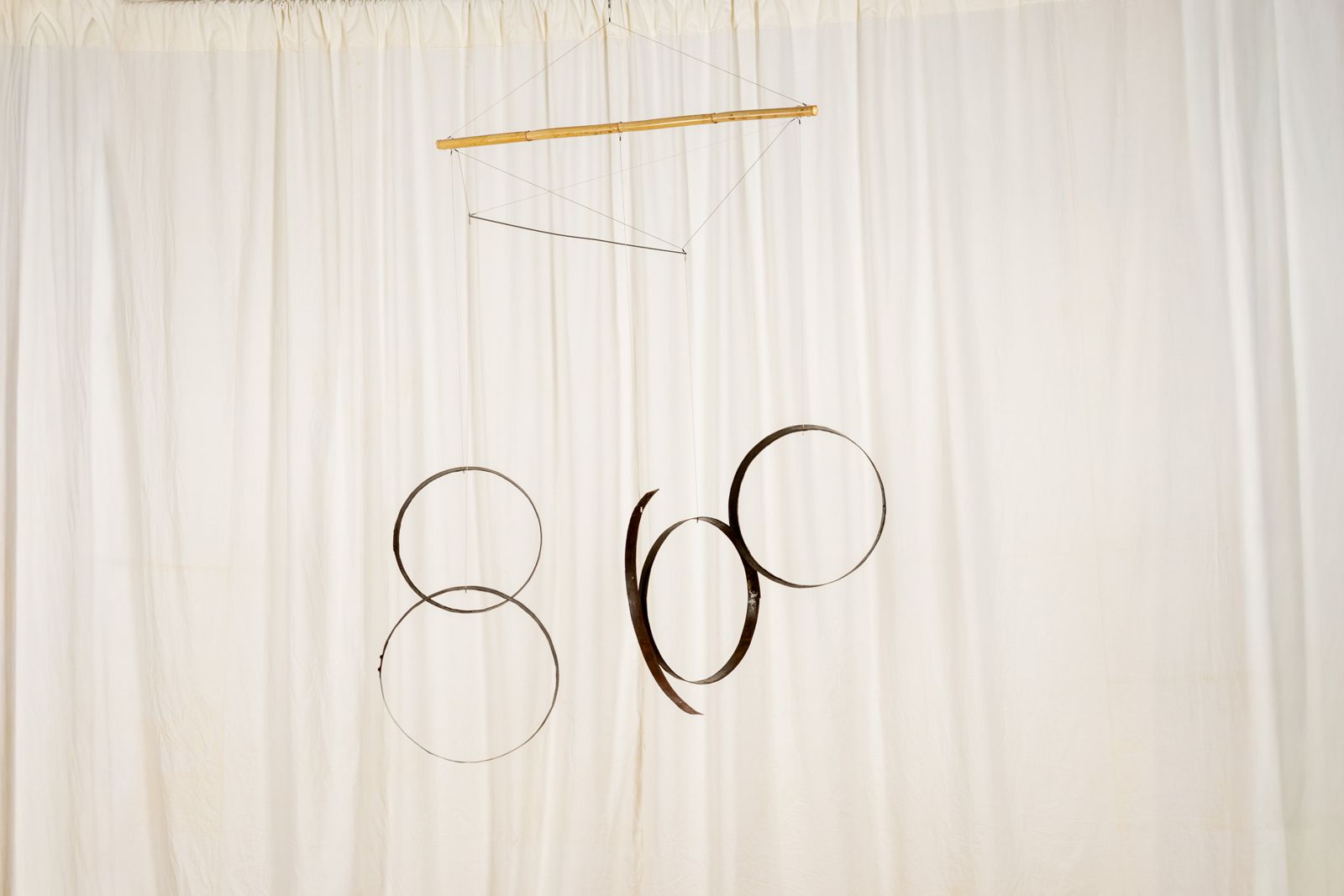 Aros 0010, suspended sculpture of reclaimed wine cask staves and hoops hanging from a cane