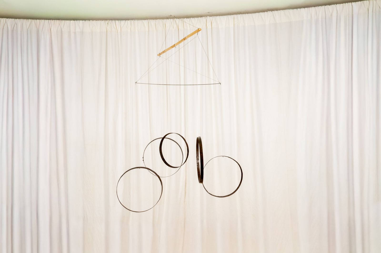 Aros 0013, suspended sculpture of reclaimed wine cask staves and hoops hanging from a cane