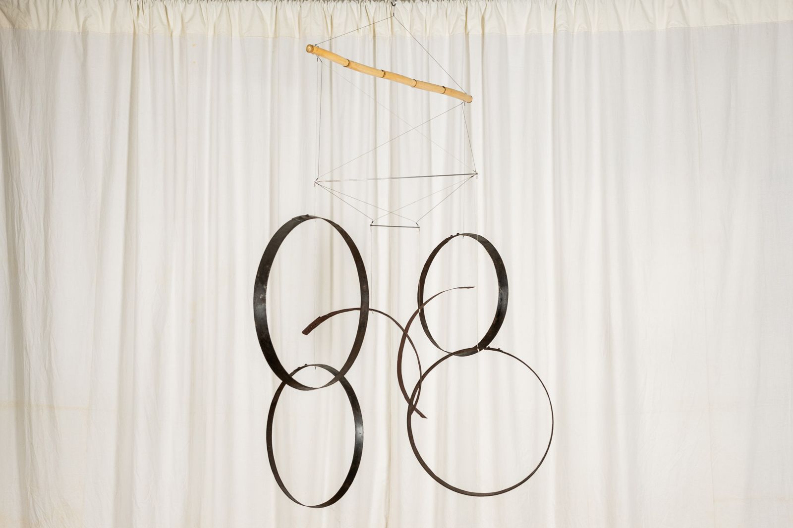 Aros 0014, suspended sculpture of reclaimed wine cask staves and hoops hanging from a cane