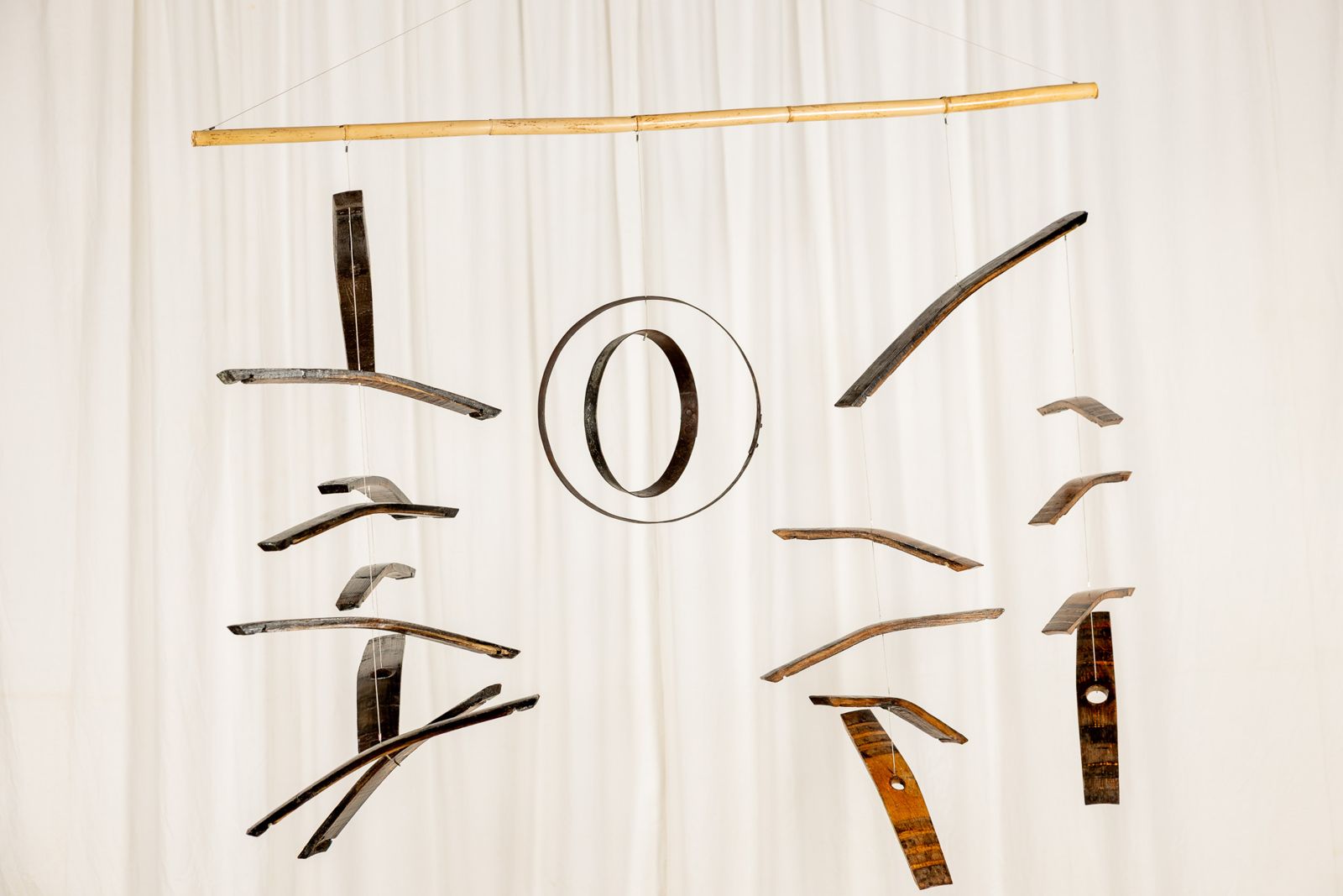 Aros Dogues 0020, suspended sculpture of reclaimed wine cask staves and hoops hanging from a cane
