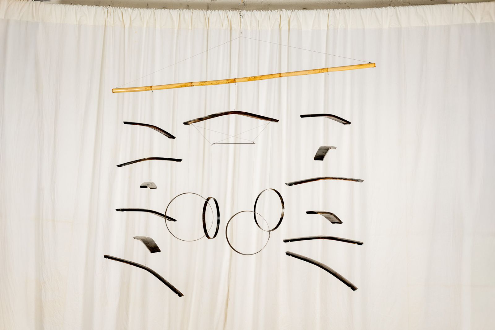 Aros Dogues 0021, suspended sculpture of reclaimed wine cask staves and hoops hanging from a cane