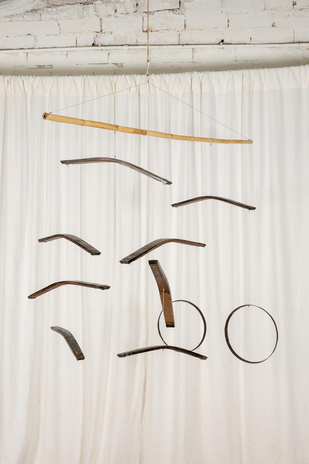 Aros Dogues 0022, suspended sculpture of reclaimed wine cask staves and hoops hanging from a cane