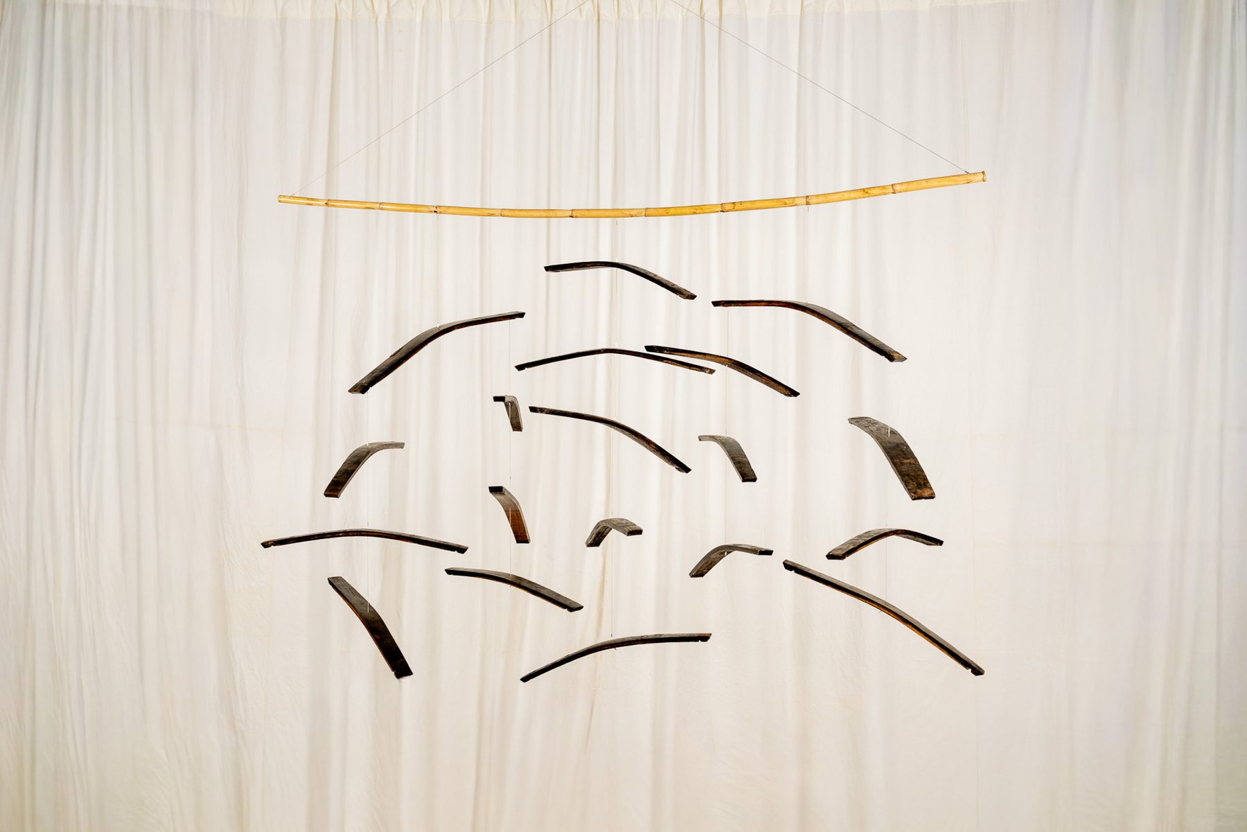 Dogues 0017, suspended sculpture of reclaimed wine cask staves and hoops hanging from a cane