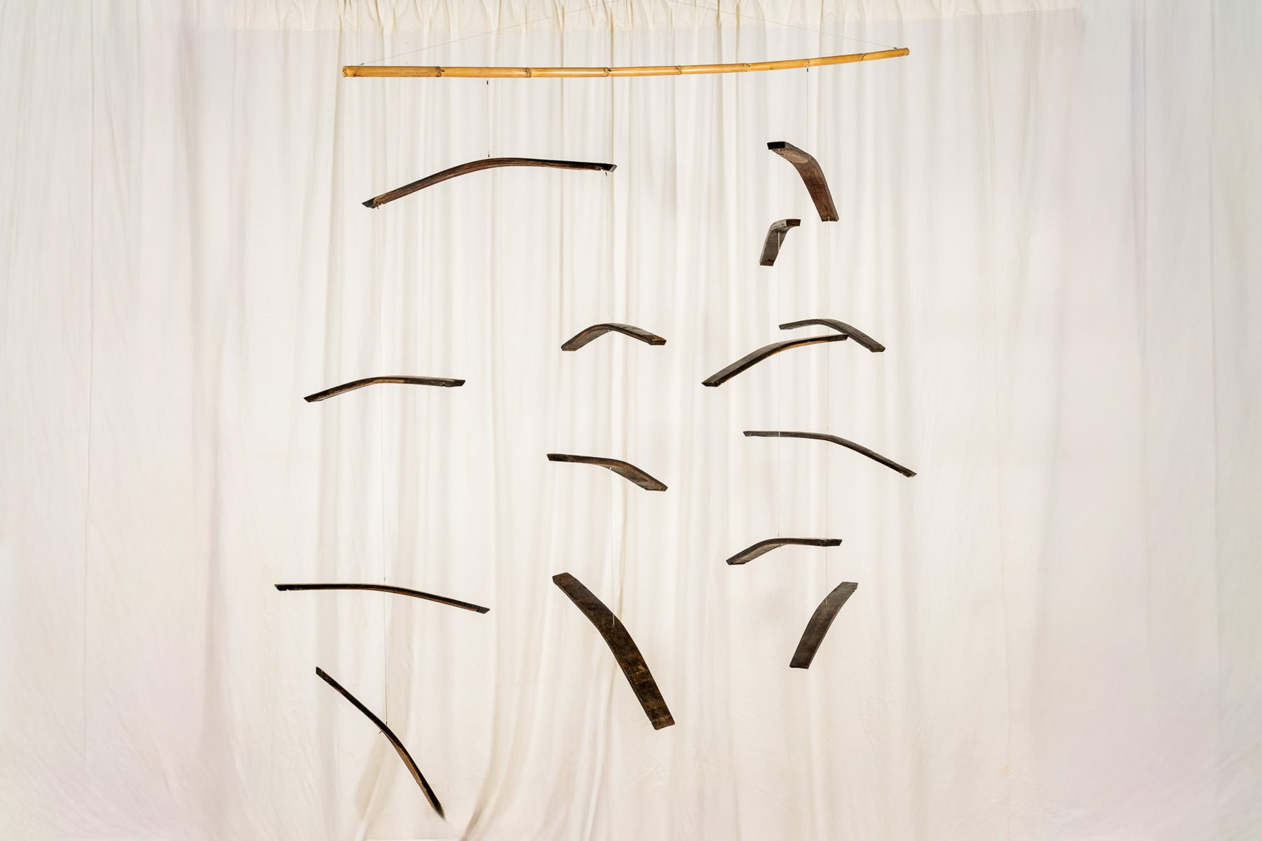 Dogues 0018, suspended sculpture of reclaimed wine cask staves and hoops hanging from a cane