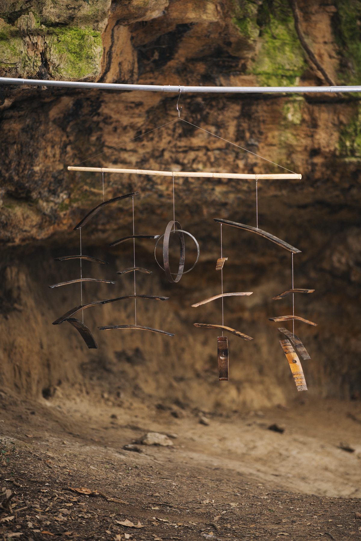 Wine cask staves and hoops mobile in front of a rock face