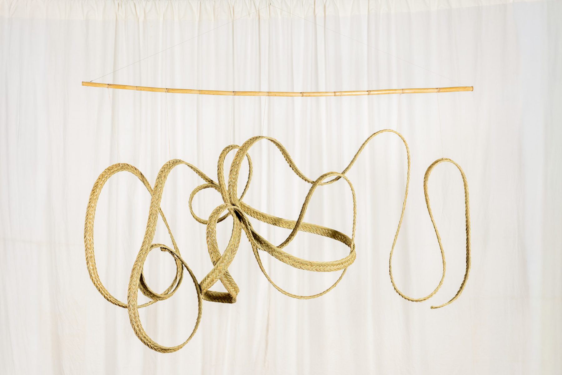 Espart 007, braided esparto sculpture suspended from a cane