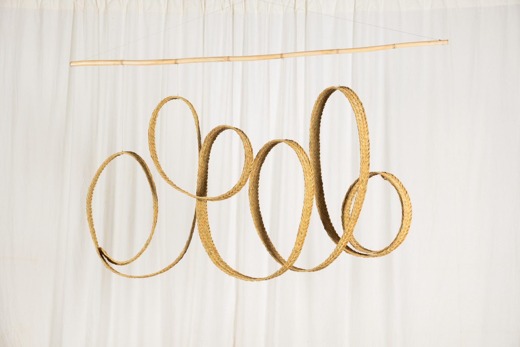 Espart 001, braided esparto sculpture suspended from a cane