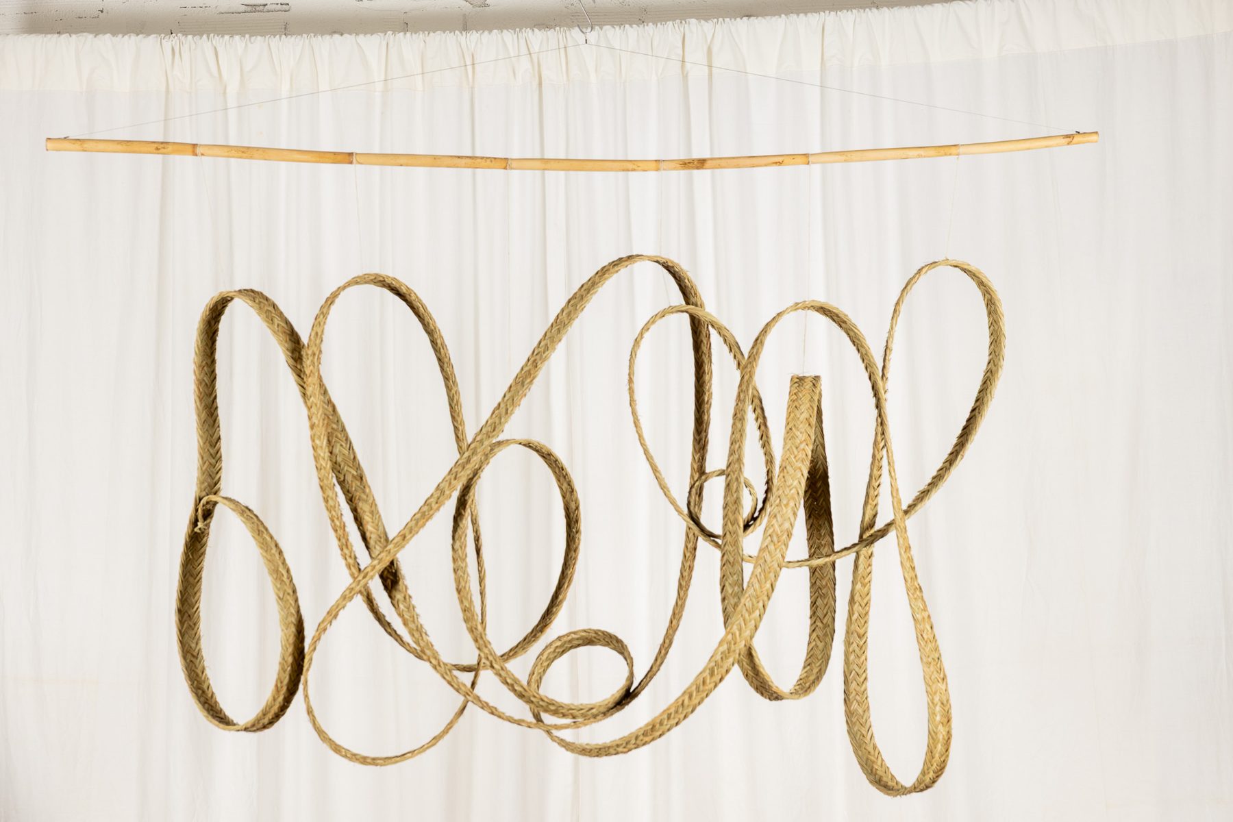 Espart 006, braided esparto sculpture suspended from a cane