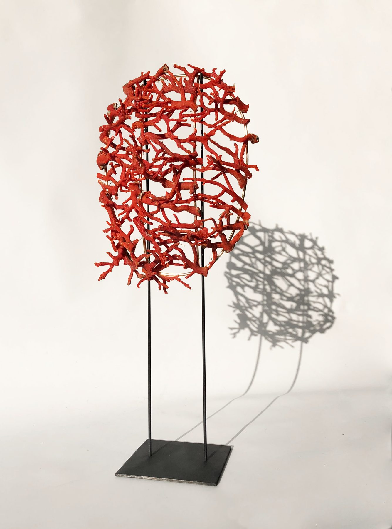 Facing Coral, red coral mask on a stand, Aloma Lafontana